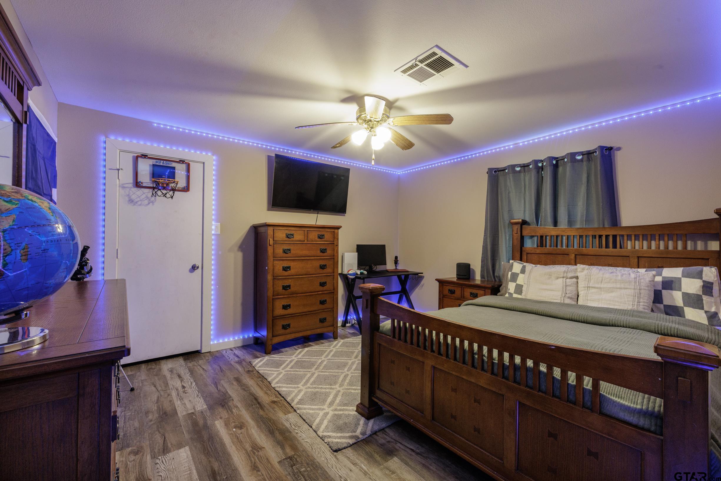 765 County Road 3410 Emory, TX 75440 - Photo 25 of 38 a bedroom with furniture and a flat screen tv