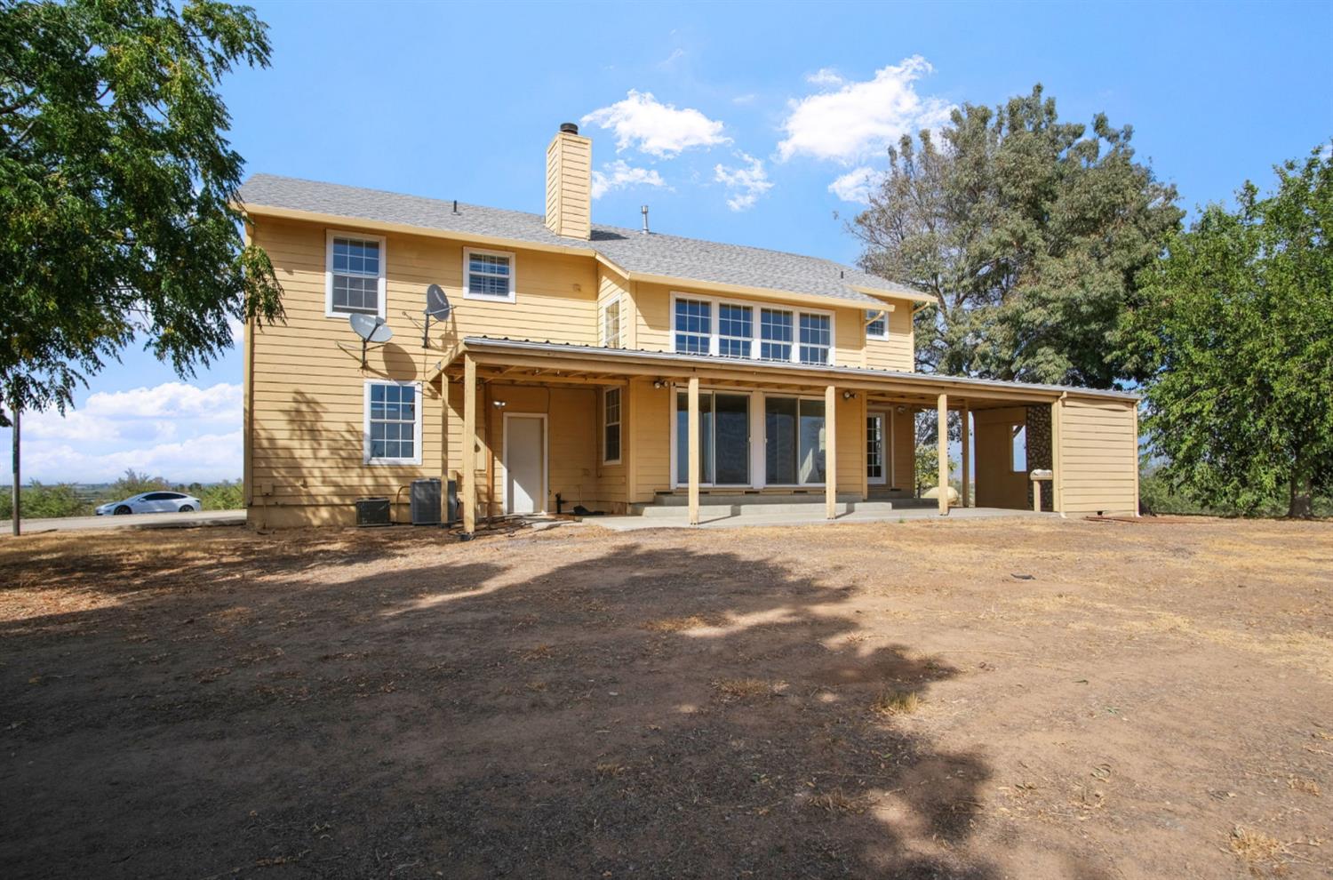 18624 Lake Road Hickman, CA 95323 - Photo 11 of 34 a front view of a house with a yard and garage