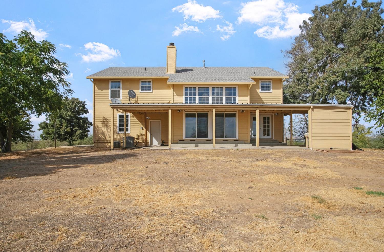 18624 Lake Road Hickman, CA 95323 - Photo 12 of 34 a front view of a house with a yard and garage