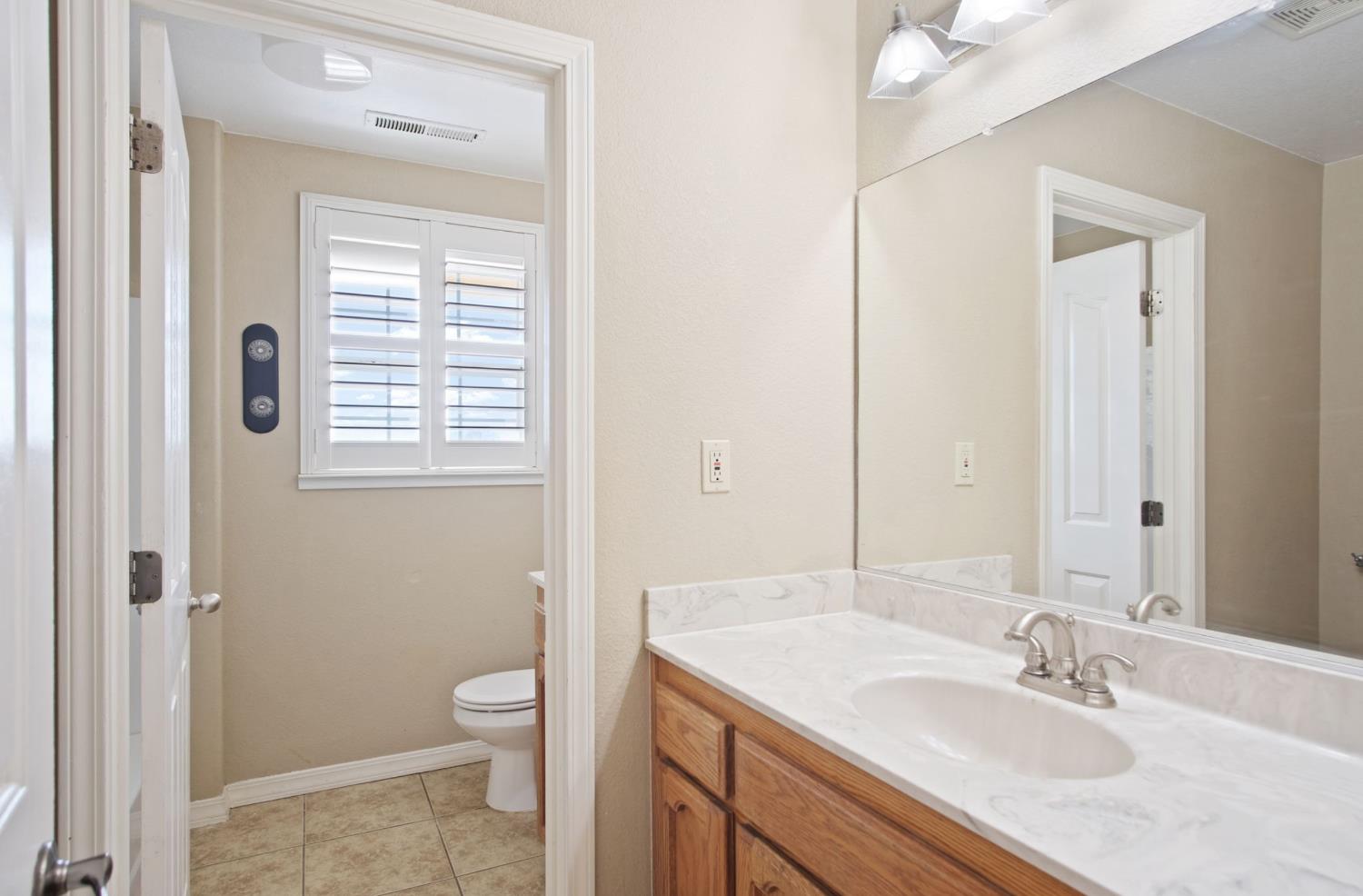 18624 Lake Road Hickman, CA 95323 - Photo 24 of 34 a bathroom with a granite countertop sink toilet and shower