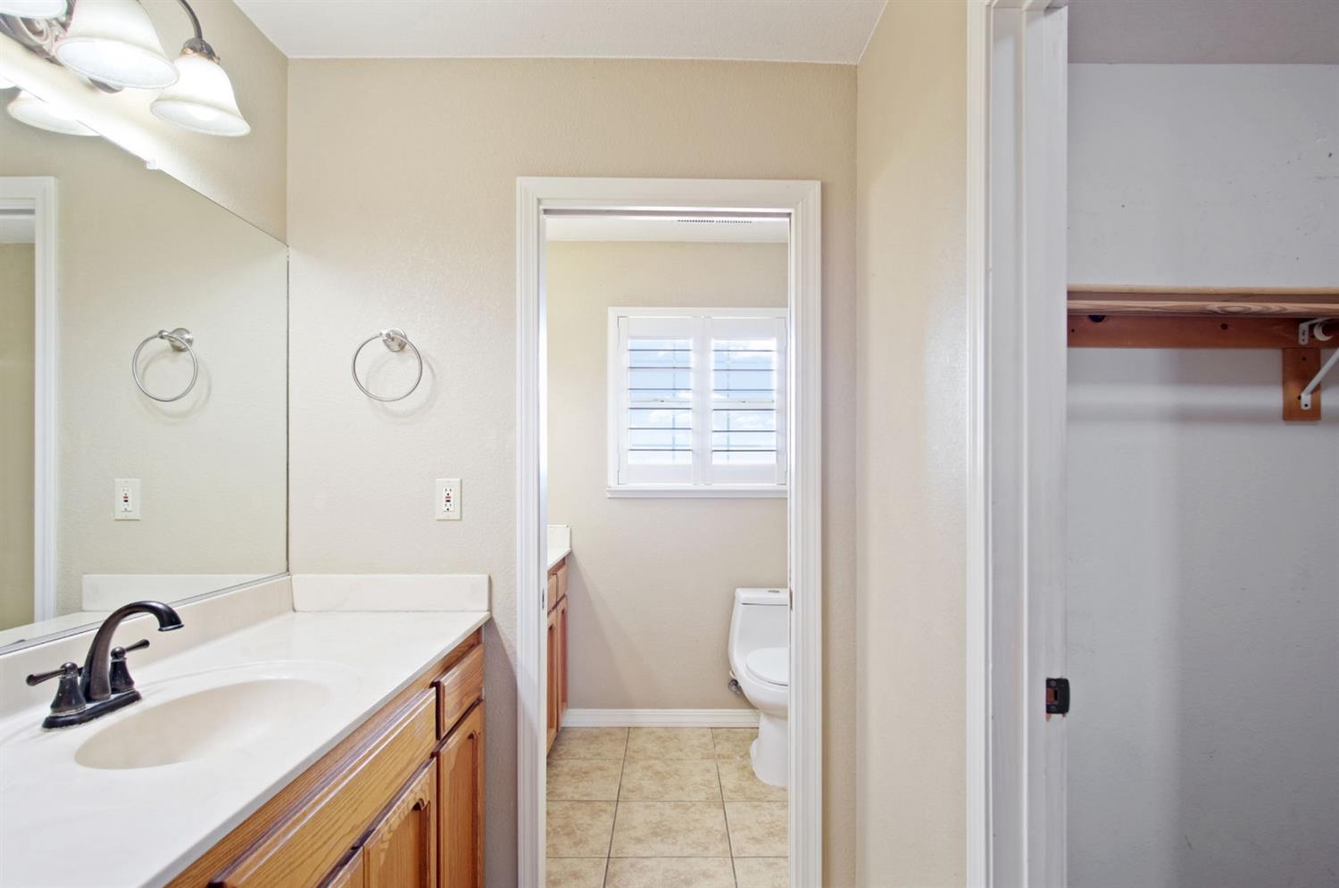 18624 Lake Road Hickman, CA 95323 - Photo 31 of 34 a bathroom with a sink a toilet and a mirror