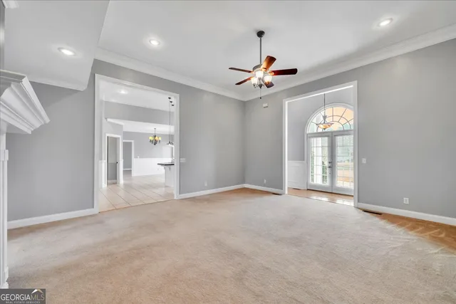 a kitchen with a sink dishwasher and white cabinets with wooden floor