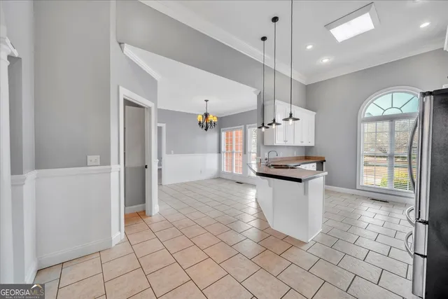 a view of an empty room with closet and a window
