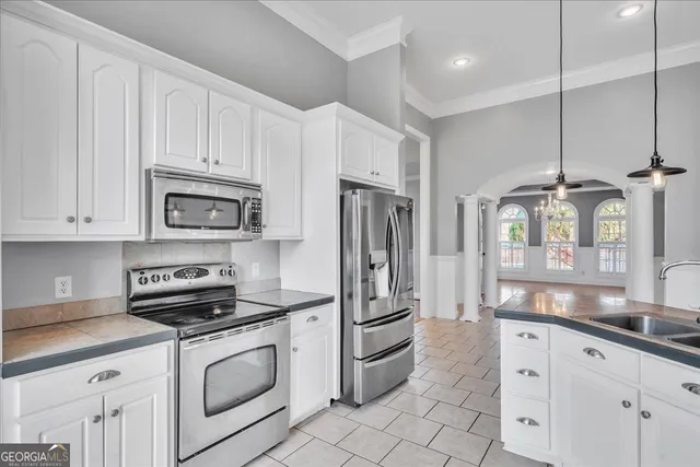 a bathroom with a granite countertop sink a toilet and shower