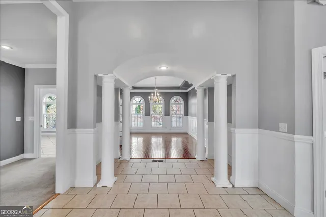 a view of an empty room with window and cabinet