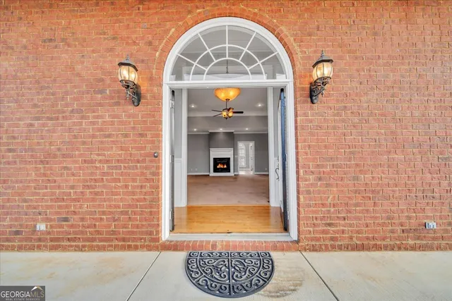 a view of an empty room with a fireplace and a window