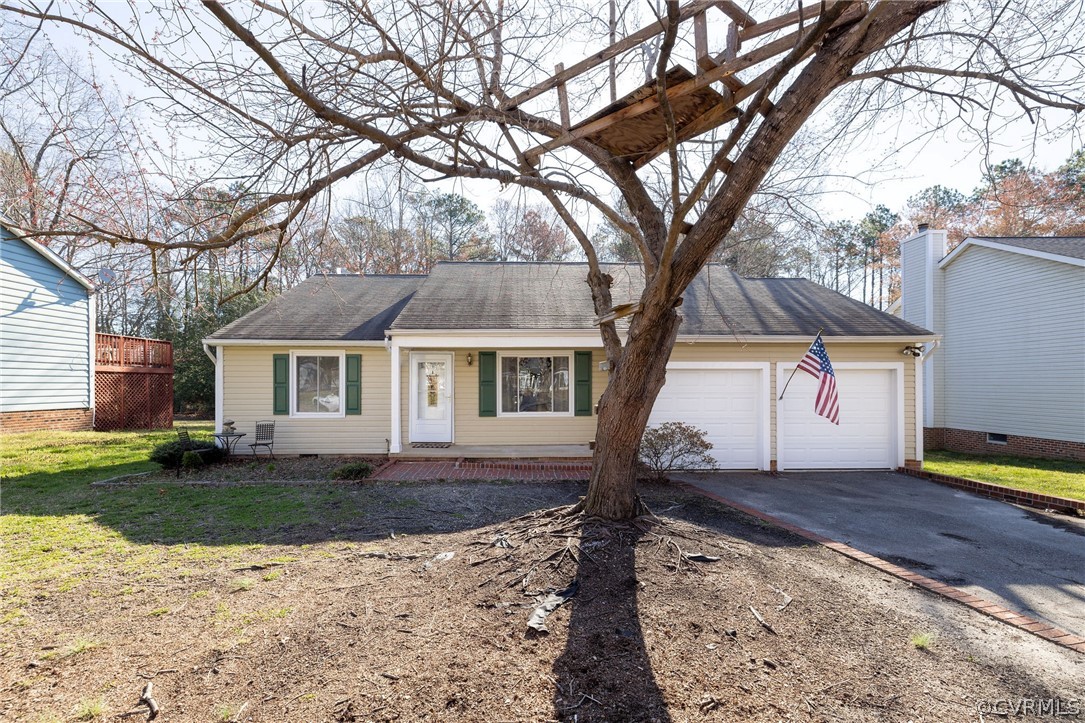 a view of a house with a tree in the yard