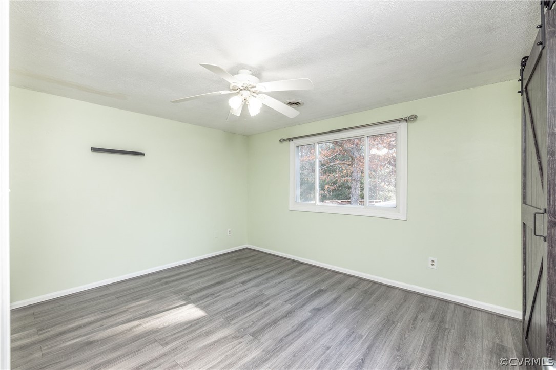 10112 Ridgerun Road Chesterfield, VA 23832 - Photo 20 of 27 a view of empty room with wooden floor and fan