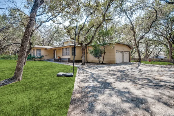 a front view of house with yard and green space