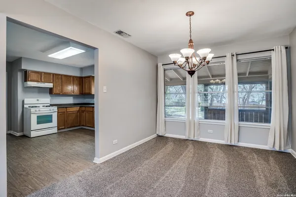 a view of a kitchen with a stove cabinets and a kitchen