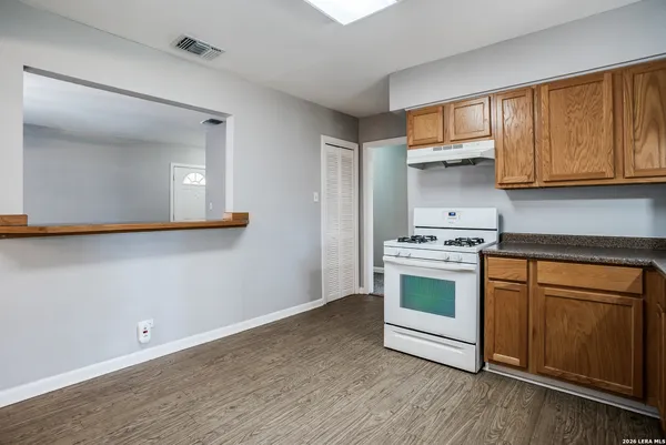 a kitchen with a white cabinets and a stove
