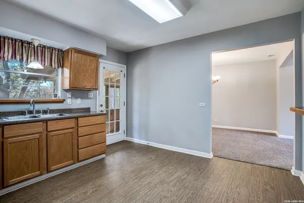 a kitchen with granite countertop wooden cabinets and a sink