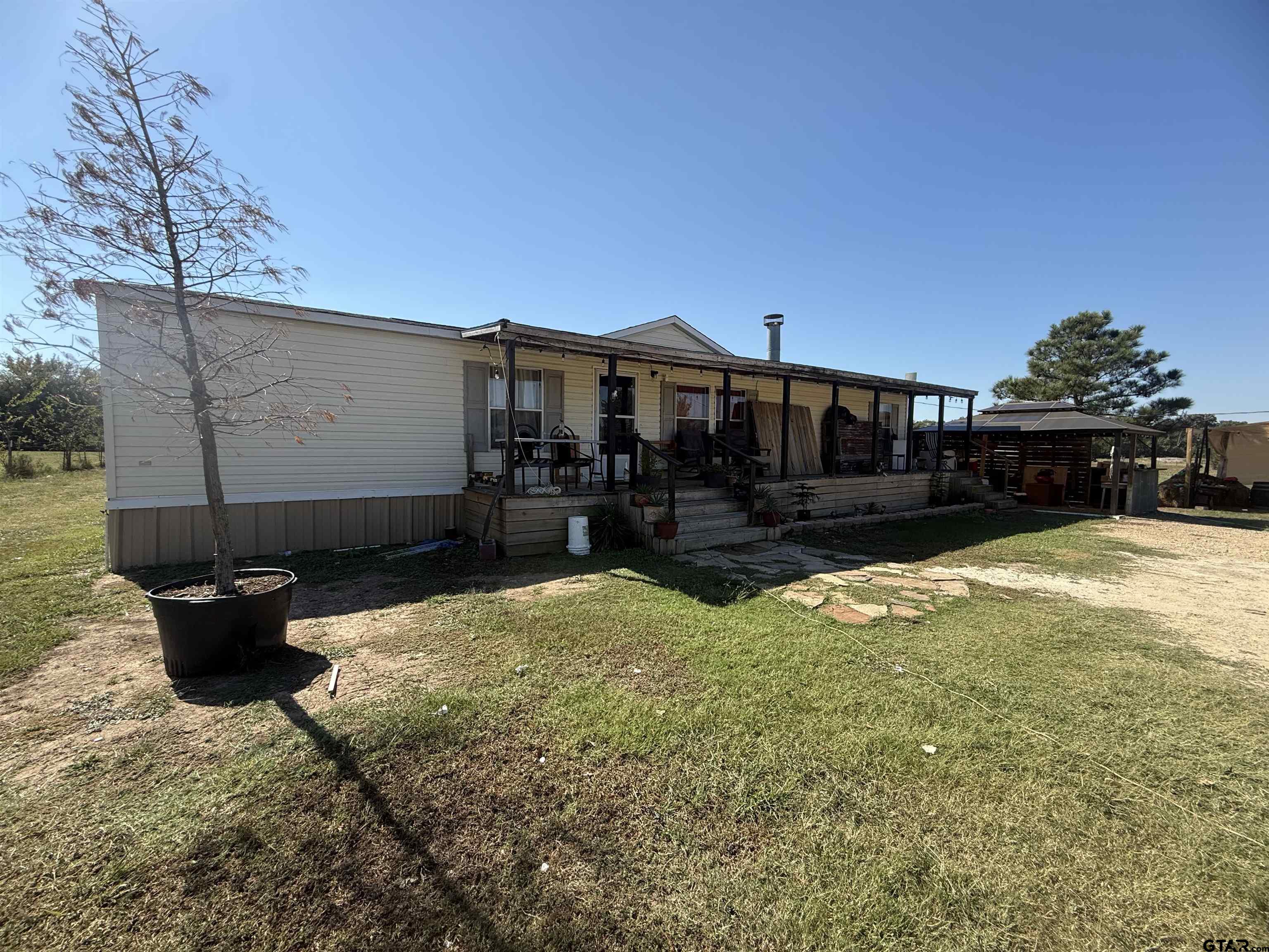 a view of a backyard with sitting area