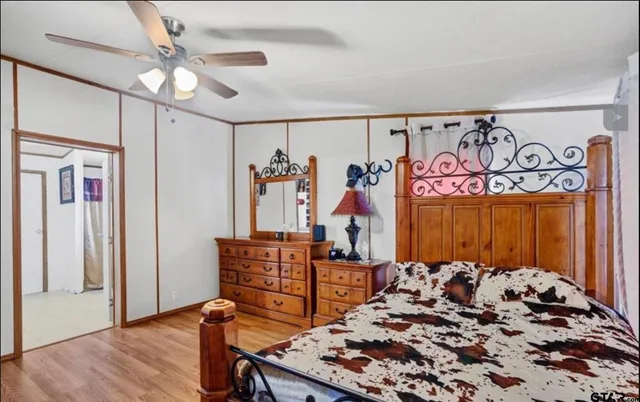 a bed sitting in a bedroom next to a window