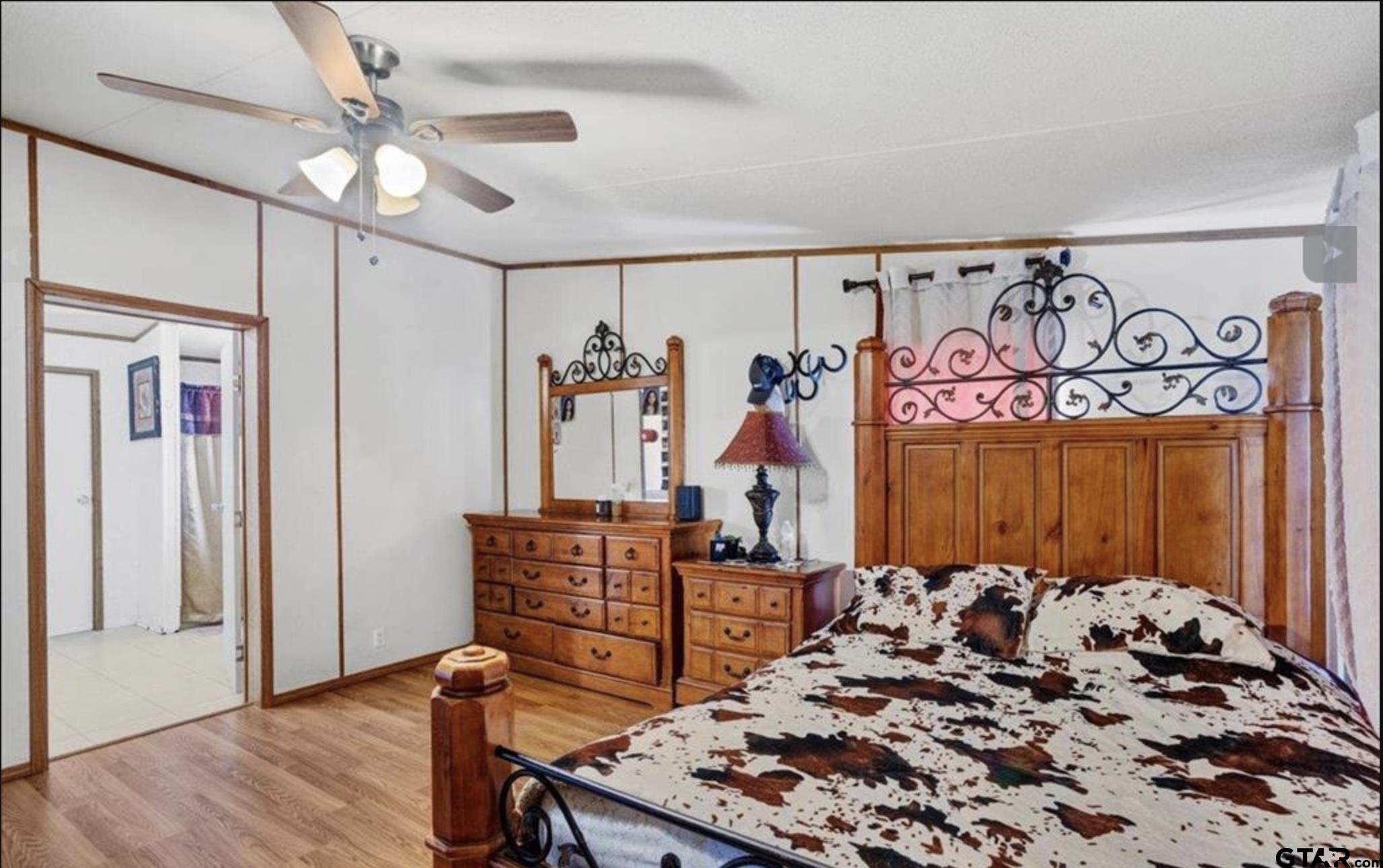 865 County Road Saltillo, TX 75478 - Photo 13 of 22 a bed sitting in a bedroom next to a window