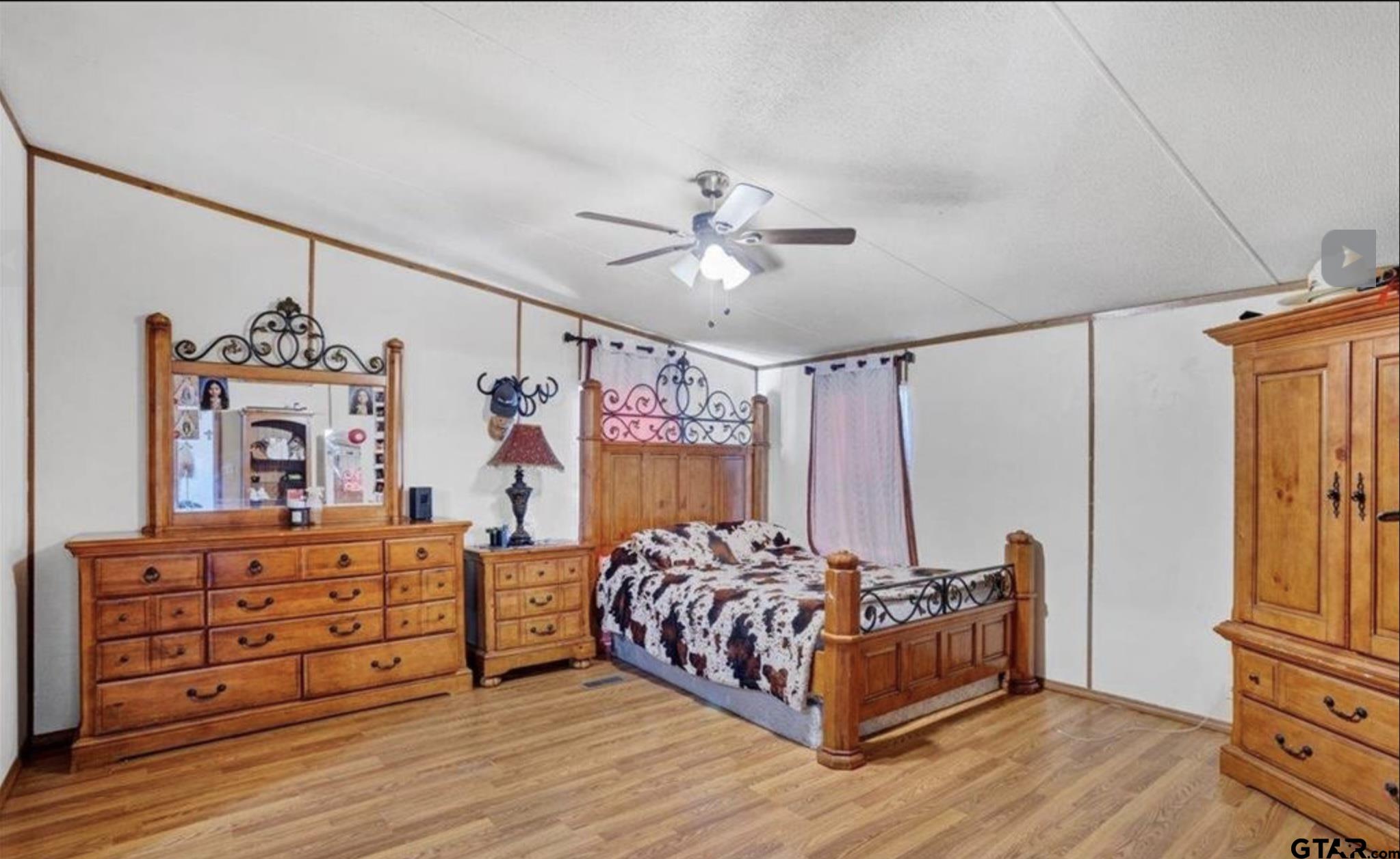 865 County Road Saltillo, TX 75478 - Photo 15 of 22 a bedroom with a bed and a chandelier