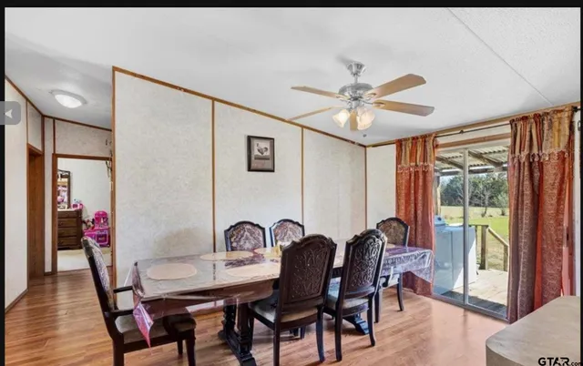 a view of a a dining room with furniture window and outside view