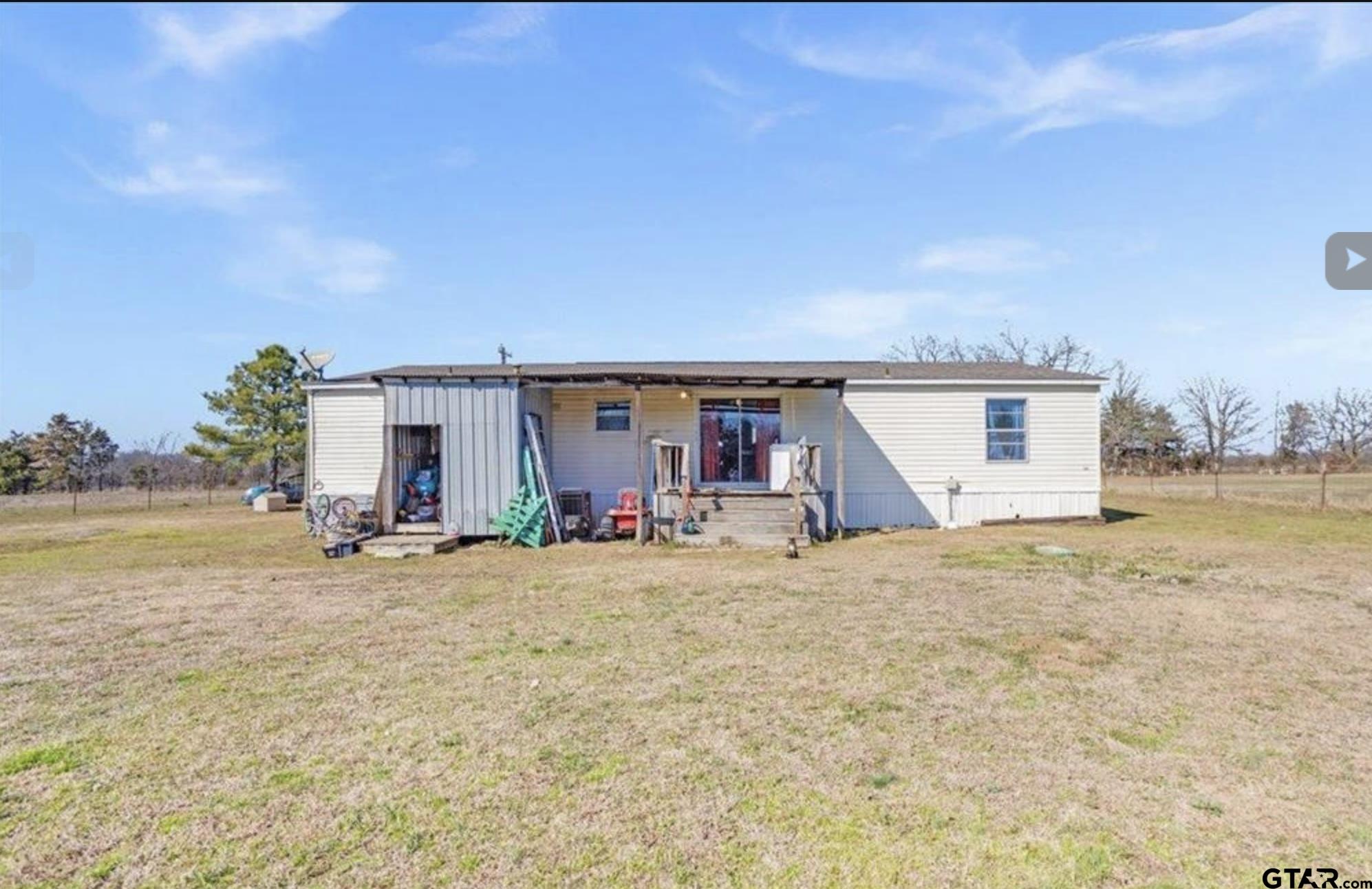 865 County Road Saltillo, TX 75478 - Photo 4 of 22 a view of a house with backyard and sitting area