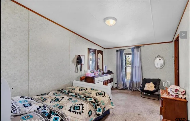 a bedroom with a bed and a dresser