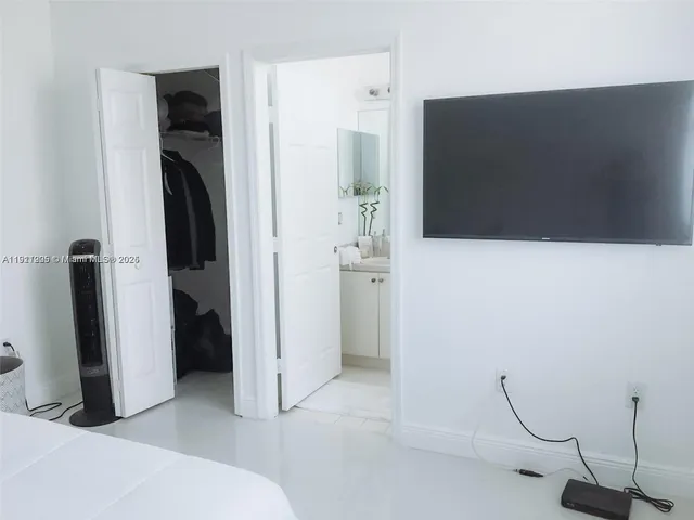 a view of a closet with wooden floor