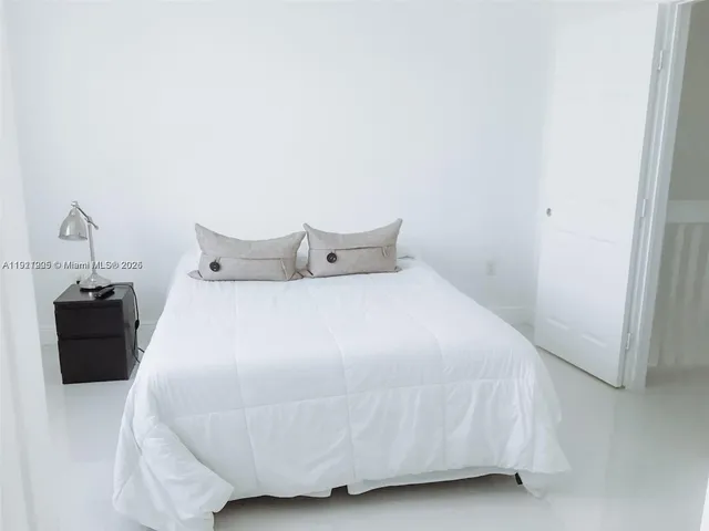 a bedroom with a bed and a table