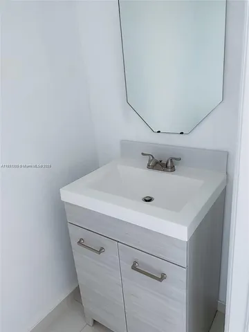 a bathroom with a sink and cabinets