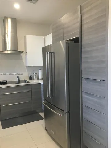 a kitchen with refrigerator and cabinets