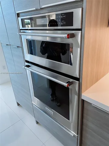 a stove top oven sitting inside of a kitchen
