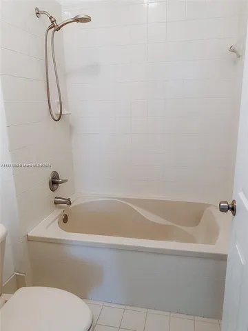 a bathroom with a bath tub with a shower