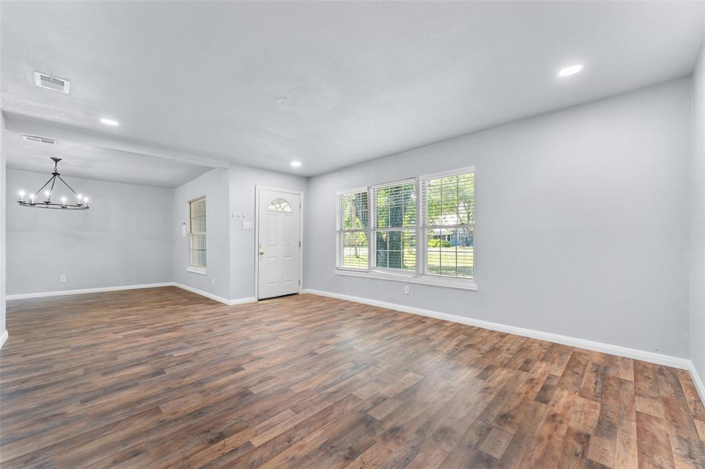 612 East 8th Street Kemp, TX 75143 - Photo 7 of 25 Open-concept living area featuring wood-finish flooring, recessed lighting, and a chandelier