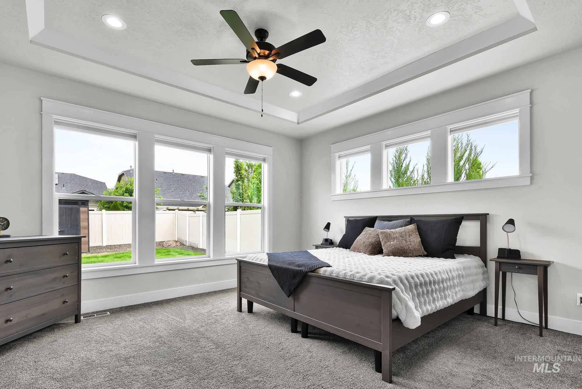 5676 East Zaffre Ridge Street Boise, ID 83716 - Photo 24 of 50 Recessed lighting illuminates a tray ceiling featuring a ceiling fan