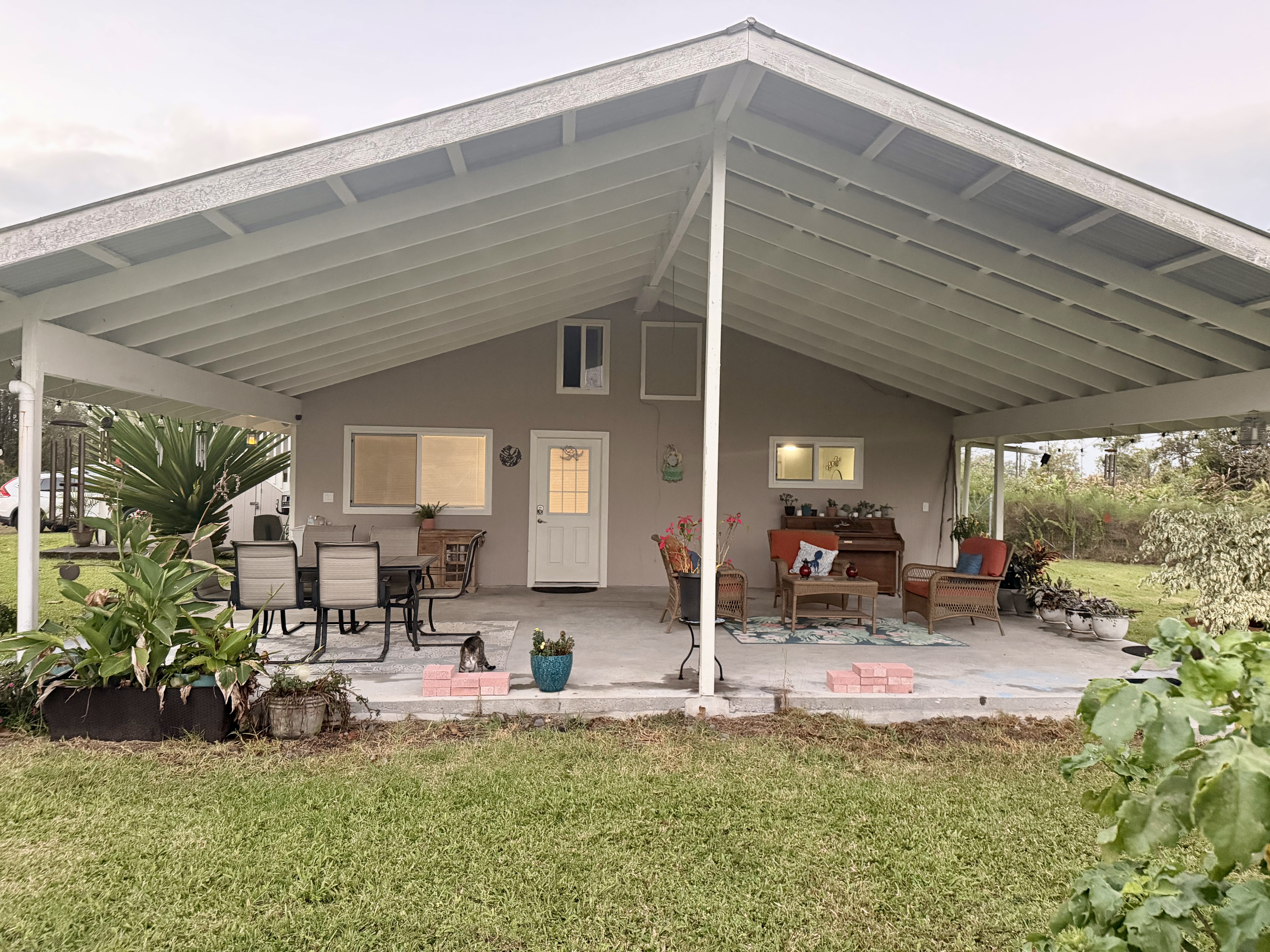 11-2485 Omeka Road Mountain View, HI 96771 - Photo 21 of 30 a view of a backyard with table and chairs potted plants and large tree