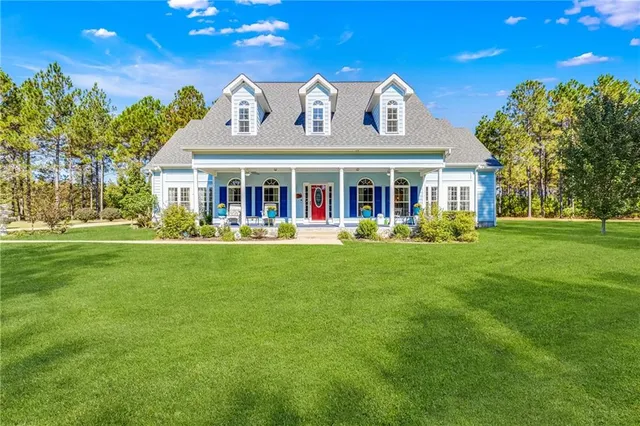 a front view of a house with a garden