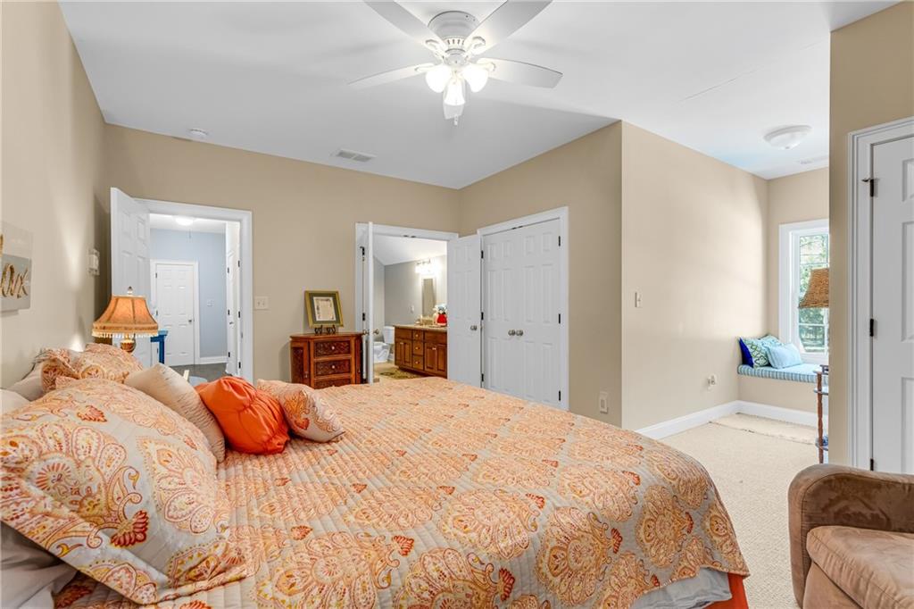 110 Bethel Village Road Eastman, GA 31023 - Photo 11 of 32 a bedroom with a bed and a chandelier