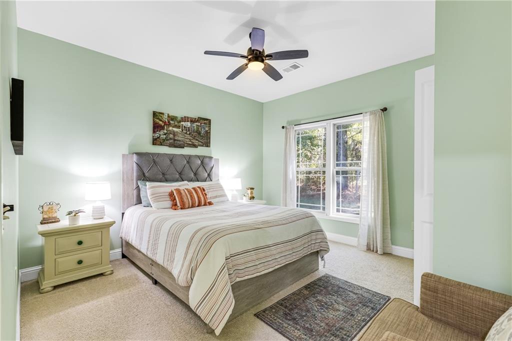 110 Bethel Village Road Eastman, GA 31023 - Photo 27 of 32 a bedroom with a bed and a chandelier