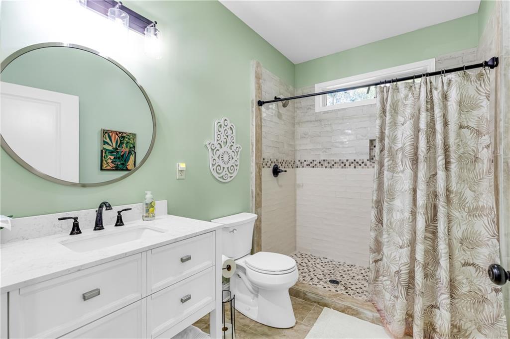 110 Bethel Village Road Eastman, GA 31023 - Photo 28 of 32 a bathroom with a toilet a sink and a mirror