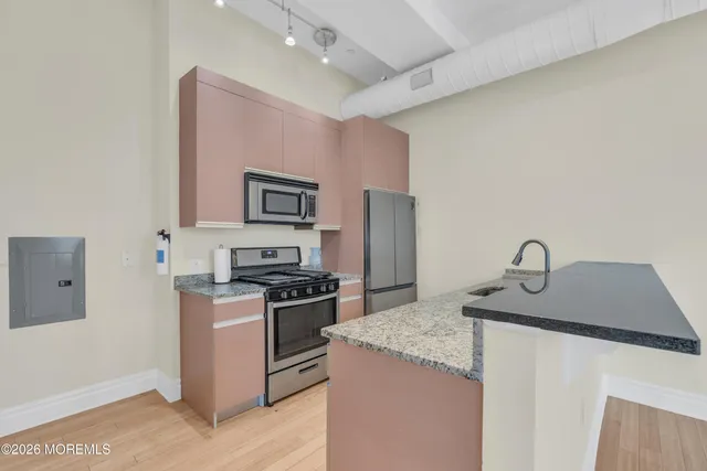 a kitchen with stainless steel appliances granite countertop a stove top oven a sink and dishwasher