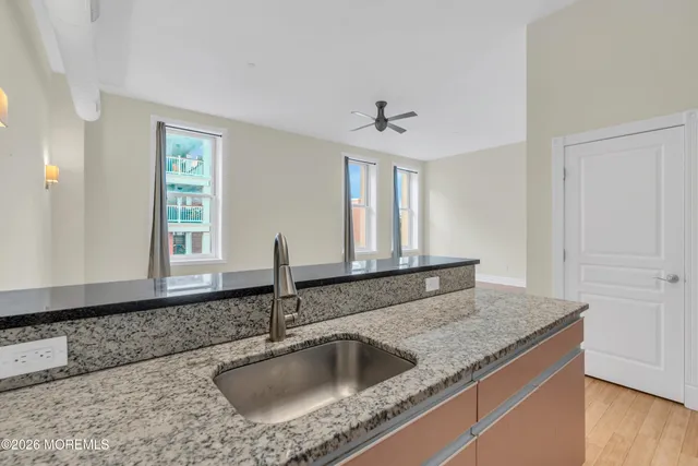 a kitchen with granite countertop a sink and a window