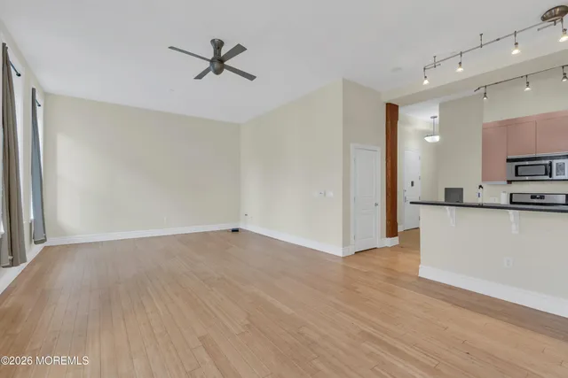 a view of a kitchen with wooden floor and a sink
