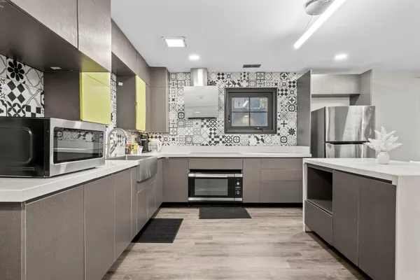 a kitchen with stainless steel appliances kitchen island a sink stove and cabinets
