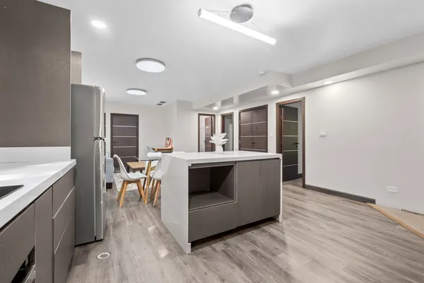 a living room with stainless steel appliances kitchen island granite countertop furniture wooden floor and a view of living room