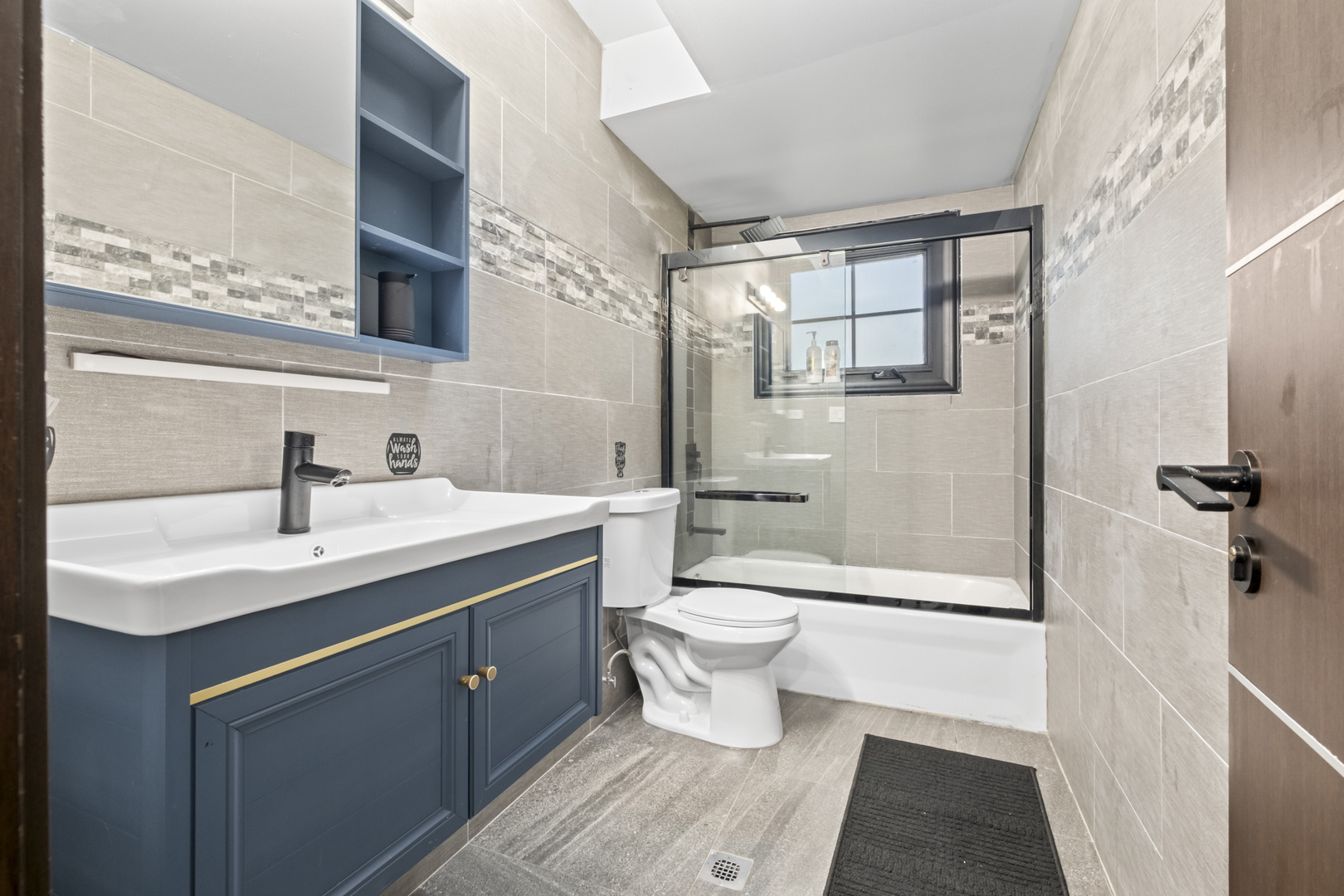 2307 Lake Street, Unit 2 Evanston, IL 60201 - Photo 17 of 20 a bathroom with a sink toilet a mirror and shower