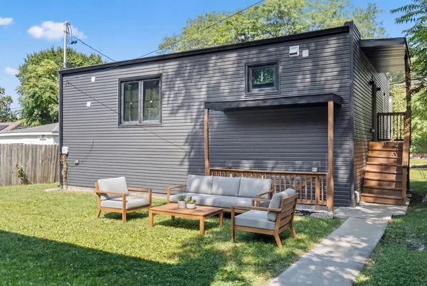 a backyard of a house with table and chairs