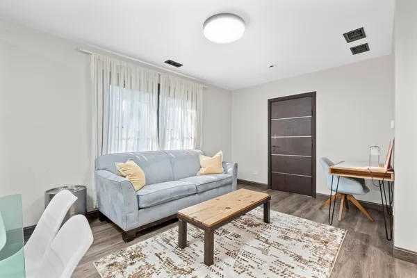 a living room with furniture a rug and a window