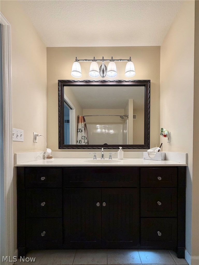 1343 Courtland Road Weirton, WV 26062 - Photo 24 of 50 Full bathroom featuring vanity, light tile patterned floors, a shower with shower curtain, and a textured ceiling