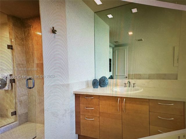 a bathroom with a granite countertop sink mirror and double