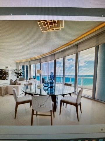 a living room with furniture and floor to ceiling windows