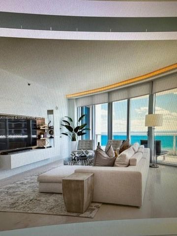 a living room with furniture and large windows