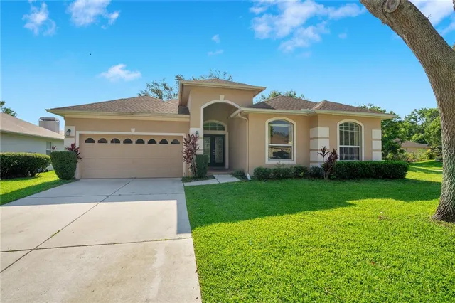 a front view of a house with a yard and garage