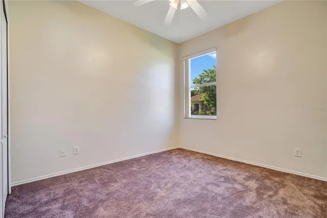 a view of a house with a big yard and large tree